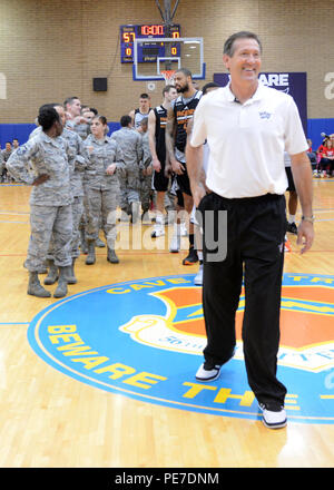 Jeff Hornacek, Phoenix Suns head coach, walks across the court after stating the rules for a half court game Nov. 5, 2015, on Luke Air Force Base, Ariz. Players were matched to Airmen and would have to make a shot from half-court to win the Airmen a personally signed jersey. (U.S. Air Force photo by Staff Sgt. Marcy Copeland) Stock Photo