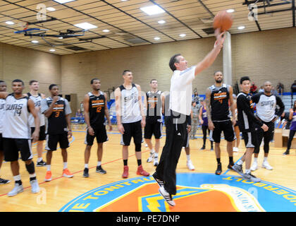 Jeff Hornacek, Phoenix Suns head coach, shoots from half court Nov. 5, 2015, on Luke Air Force Base, Ariz. Hornacek took one shot from half court and swooshed it the first try sending the crowd and players cheering. (U.S. Air Force photo by Staff Sgt. Marcy Copeland) Stock Photo