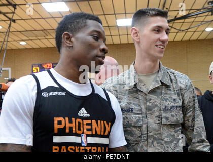 Eric Bledsoe, Phoenix Suns guard, poses with Airman 1st Class Michael Wenner, 56th Medical Support Squadron medical lab technician, after the Phoenix Suns practice demonstration Nov. 5, 2015, on Luke Air Force Base, Ariz. The Phoenix Suns came to Luke to show support for their troops. (U.S. Air Force photo by Staff Sgt. Marcy Copeland) Stock Photo