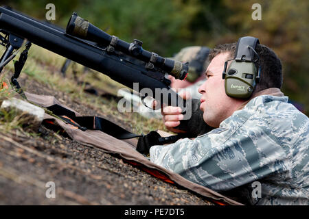 Senior Airman Evan Smith, of the 188th Security Forces Squadron, looks down the sights of his M24 rifle Nov. 6, 2015, during known distance sniper and advanced designated marksman qualification at Fort Chaffee Joint Maneuver Training Center, Ark. The 188th SFS maintains combat readiness and efficiency through annual training on their designated weapons systems which allows them to remain proficient as marksmen. The training consisted of qualifications at 100, 300, 400, and 500 yards and with moving targets at designated distances. (U.S. Air National Guard photo by Capt. Holli Nelson) Stock Photo