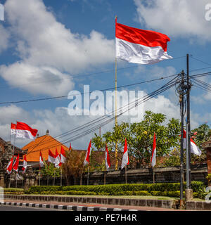 Flags at the streets of Bali before celebration on Indonesian Independence day. Bali, Indonesia Stock Photo