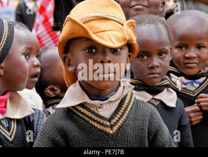 Young children, some in school uniform, one boy wearing a wonderful hat, Karatina, Kenya Stock Photo