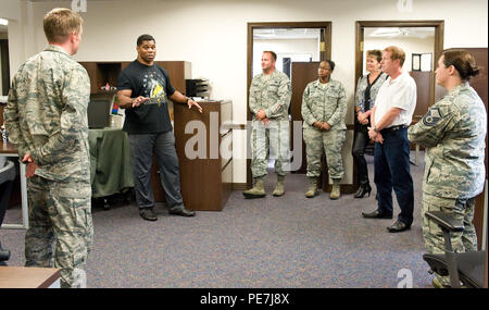 Herschel Walker, second from left, chats with members of the 436th Airlift Wing Safety Office Oct. 13, 2015, on Dover Air Force Base, Del. Walker shared stories about his upbringing, family, business and sports career, including his experience and treatment of Dissociative Identity Disorder by seeking the help of behavioral health professionals. (U.S. Air Force photo/Roland Balik) Stock Photo