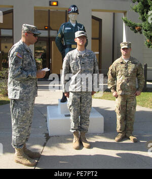 Capt. Aedro Rodriguez (left), provost marshal of the 2nd Armored Brigade Combat Team, 1st Cavalry Division, officially recognizes Pfc. Shin Sang-wook as a Korean Augmentation to the United States Army Soldier for the brigade provost marshal office at the military police station, Camp Casey, South Korea Sept. 18. Shin was originally stationed in the Republic of Korea Army staff office as an interpreter and translator. (U.S. Army photo by Pfc. Kim Ji-won, 2nd ABCT ROKA Staff) Stock Photo