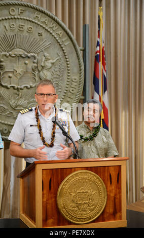 Capt. James Jenkins, Coast Guard 14th District chief of staff, provides remarks after David Ige, Hawaii state governor, read a proclamation announcing the completion of the Anuenue Interisland Digital Microwave Network, at the Hawaii State Capitol in Honolulu, Oct. 22, 2015. Twelve Anuenue “high sites” located on mountaintops in many at remote locations connect with eight sites located at state office buildings and Coast Guard properties. (U.S. Coast Guard photo by Petty Officer 2nd Class Tara Molle/Released) Stock Photo