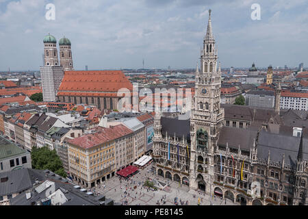 New City Hall and Frauenkirche Cathedral in the Marienplatz square of Munich, Germany are shown in a daytime, elevated view. Stock Photo