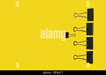 four big paper clips against small one Stock Photo