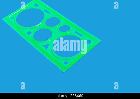 green ruler isolated on the blue surface Stock Photo