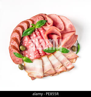Antipasto set platter isolated on white background. Cold smoked meat plate with sausage, sliced ham,prosciutto,bacon,olives,basil. Copy space. Top vie Stock Photo