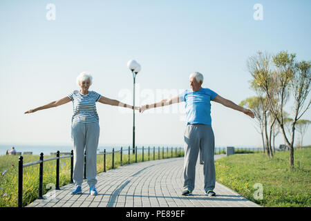 Senior Couple Exercising Outdoors Stock Photo