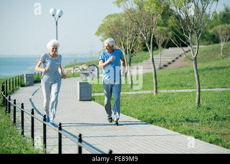 Senior Couple Running Outdoors Stock Photo