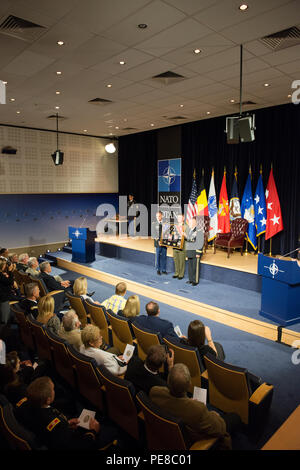 U.S. Army Col. James Becker and U.S. Marines Corps Col. Philippe D. Rogers, both with U.S. Delegation NATO, present a shadow box retracing his career to U.S. Army Lt. Gen. David R. Hogg during his retirement ceremony at NATO Headquarters' auditorium, in Brussels, Belgium, Sept. 15, 2015. (U.S. Army photo by Visual Information Specialist Pierre Courtejoie/Released) Stock Photo