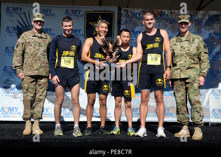 The Joint Base Myer-Henderson Hall Active Duty Mixed Masters Army Ten-Miler race team poses for a photo with Joint Force Headquarters-National Capital Region and U.S. Army Military District of Washington Commander Maj. Gen. Bradley A. Becker (far left) and JFHQ-NCR/MDW Command Sgt. Maj. Timothy A. Guden. JBM-HH took home the title in the active duty masters mixed division, which consists of teams of male and female U.S. service members age 40 or older from the same duty station, installation, division, center or group. Pictured here accepting the award are four of the team's six members: From  Stock Photo