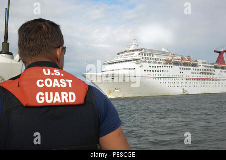 Petty Officer 3rd Class Carlos Rodriguez, a machinery technician from Coast Guard Station Mayport, Fla., prepares to conduct a medical evacuation of a cruise ship passenger in the Jacksonville jetties, Oct. 23, 2015. The passenger was taken off the Carnival Fantasy and transferred to EMS after suffering symptoms of a heart attack. (U.S. Coast Guard photo by Petty Officer 2nd Class Anthony L. Soto) Stock Photo