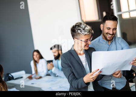 Young designers talking on break about business plans Stock Photo