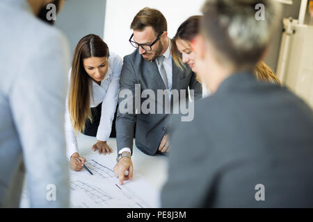 Team of architects working on construction plans Stock Photo