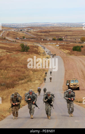 Silver spur candidates conduct a 12-mile ruck march while carrying more than 55 pounds of gear during a Spur Ride hosted by 2nd Squadron, 1st Cavalry Regiment, 1st Stryker Brigade Combat Team, 4th Infantry Division, Oct. 28, 2015.  After a physical training assessment spur, candidates were tested with vehicle maintenance lanes, a written test, stress shoot, 12-mile ruck march and situational training exercises under combat simulated conditions for two days. Stock Photo