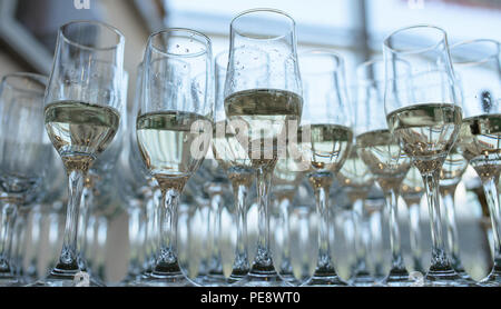 View from below of half full champagne or bubbly flutes, a typical wedding reception or party welcome for the guests Stock Photo