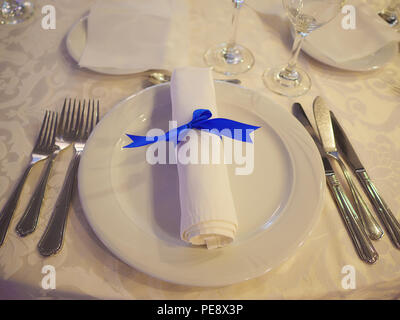 Table setting for formal event, elegant dining or a wedding, ready for guests, with the silverware placed in the order of use, and napkin Stock Photo
