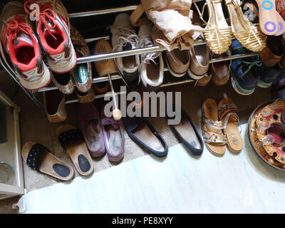 Shoe rack collection in a 20 year old girls bedroom in a large French house Stock Photo