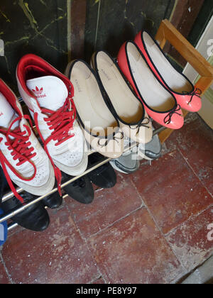 Shoe rack collection in a 20 year old girls bedroom in a large French house Stock Photo