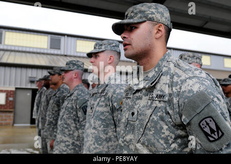 Soldiers assigned to 5th Battalion, 5th Air Defense Artillery Regiment, 31st Air Defense Artillery Brigade, sing the Army Song during a deployment ceremony on Joint Base Lewis-McChord, Wash., Nov. 9, 2015. The “Dragon Slayers,” which fall under 17th Field Artillery Brigade while assigned to JBLM, are deploying a small contingent of the unit in support of U.S. Central Command conducting operations in Southwest Asia. (U.S. Army photos by Sgt. 1st Class Andrew Porch, 28th Public Affairs Detachment) Stock Photo