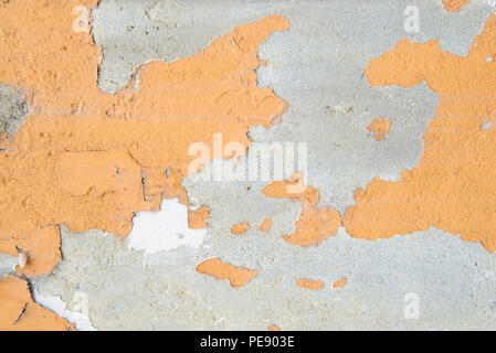 Orange color painted on cement wall are peeling Stock Photo