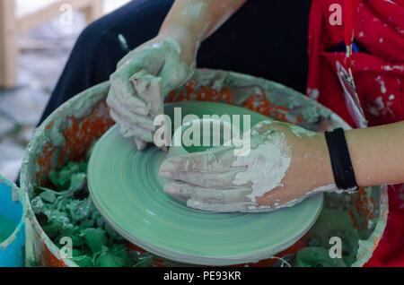 wheel.Hands making clay from various items for home and sale in the store. Stock Photo