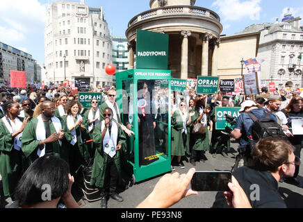 A large gospel choir brings the noise to the anti-Trump protest, delivering a potential saviour in the shape of Oprah Winfrey, as Paddy Power slash the talk show host's Presidential odds to 20/1. 'Oprahtic' were in full voice as they wheeled a lifelike waxwork of Winfrey through the march, following a survey in which 71% of Brits said they would like her to run.  Featuring: Atmosphere Where: London, United Kingdom When: 13 Jul 2018 Credit: Joe Pepler/PinPep/WENN.com Stock Photo