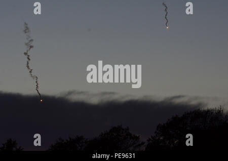 Two illumination rounds can be seen in the distant sky that soldiers of Apache Troop and Charlie Troop 5th Squadron, 7th Cavalry Regiment, stationed at Fort Stewart, Ga., fired from an M1064A3 Mortar Carrier during a field training exercise in Bulgaria, Nov. 11, 2015.  Illumination rounds are used to reveal the location of enemy forces hidden by darkness and allow the commander to confirm or deny the presence of the enemy without revealing the location of friendly direct-fire weapons. Stock Photo