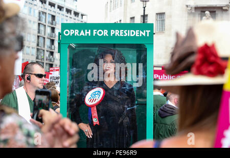 A large gospel choir brings the noise to the anti-Trump protest, delivering a potential saviour in the shape of Oprah Winfrey, as Paddy Power slash the talk show host's Presidential odds to 20/1. 'Oprahtic' were in full voice as they wheeled a lifelike waxwork of Winfrey through the march, following a survey in which 71% of Brits said they would like her to run.  Featuring: Atmosphere Where: London, United Kingdom When: 13 Jul 2018 Credit: Joe Pepler/PinPep/WENN.com Stock Photo