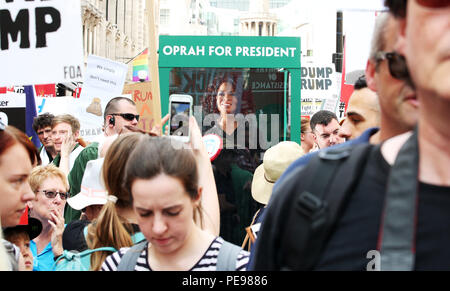 A large gospel choir brings the noise to the anti-Trump protest, delivering a potential saviour in the shape of Oprah Winfrey, as Paddy Power slash the talk show host's Presidential odds to 20/1. 'Oprahtic' were in full voice as they wheeled a lifelike waxwork of Winfrey through the march, following a survey in which 71% of Brits said they would like her to run.  Featuring: Atmosphere Where: London, United Kingdom When: 13 Jul 2018 Credit: Joe Pepler/PinPep/WENN.com Stock Photo