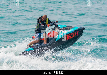 A man riding a jet ski on the sea.in Summer in the UK. Jet ski. Jet skiing. Stock Photo