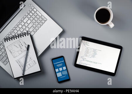 website development in process. wireframe sketch and programming code Stock Photo