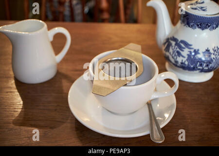 tea strainer on a cup of tea in a tea shop in Bath England UK Stock Photo