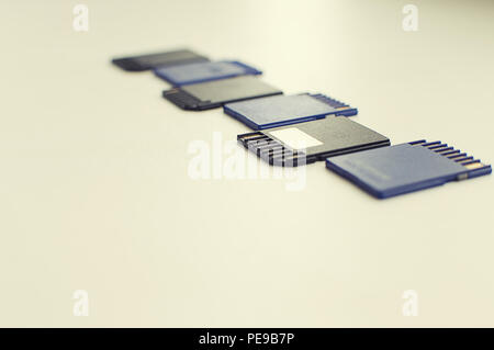 a set of flash drives lies on a white table Stock Photo