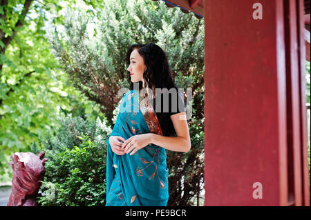 Portrait of beautiful indian brumette girl or hindu woman model against japanese traditional house. Stock Photo
