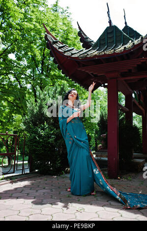 Portrait of beautiful indian brumette girl or hindu woman model against japanese traditional house. Stock Photo