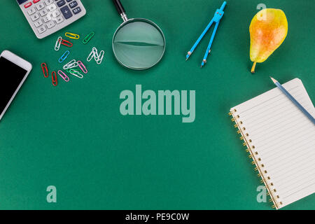School supplies with copy space on green background. Stock Photo