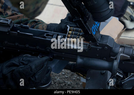 A Marine with Headquarters and Service Battalion loads ammunition ...