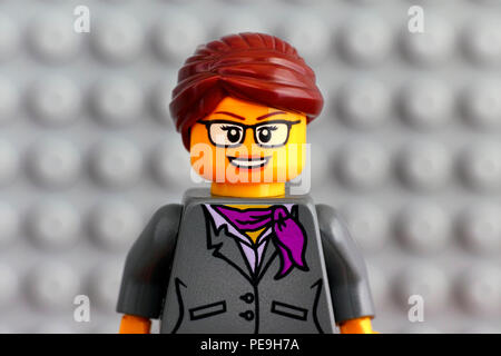 Tambov, Russian Federation - July 29, 2018 Portrait of Lego businesswoman minifigure with gray baseplate background. Studio shot. Stock Photo