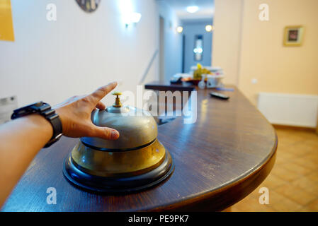 Hand ringing in service bell at hotel Stock Photo