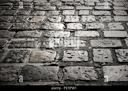 old cobble stone road surface paving dark night background texture Stock Photo