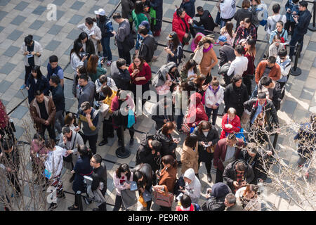 People queuing up for an event in a shopping mall in Beijing Stock Photo