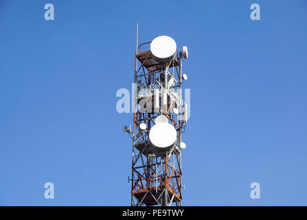 telecommunication mast TV antennas wireless technology with blue sky in the morning Stock Photo