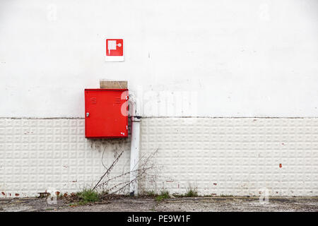an fire hose hanging on the wall Stock Photo