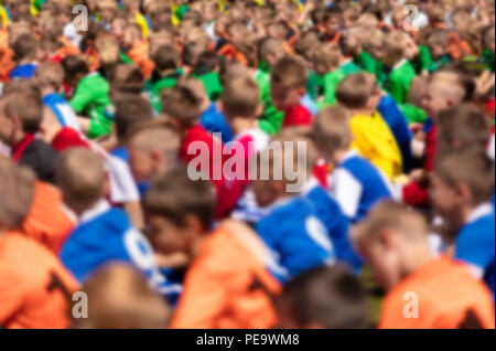 Kids Sport Football Players Sitting on a Sports Field. Youth Football Background. Soccer Tournament for Kids Stock Photo