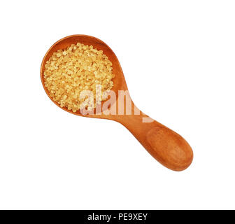Close up one wooden scoop spoon of brown cane sugar isolated on white background, top view Stock Photo
