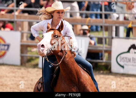 Cowgirls guide their quarterhorses through the Pole Bending course during the Ram Rode Tour in Exeter, Ontario, Canada. Stock Photo