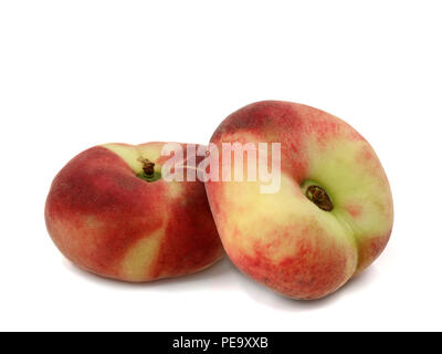 Prunus Persica, two flat peaches isolated on a white background Stock Photo